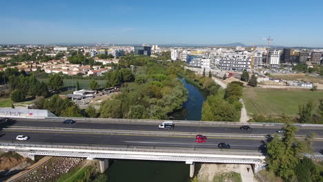 Aerial-drone-shot-over-a-bridge-with-traffic-Montpellier-port-Marianne